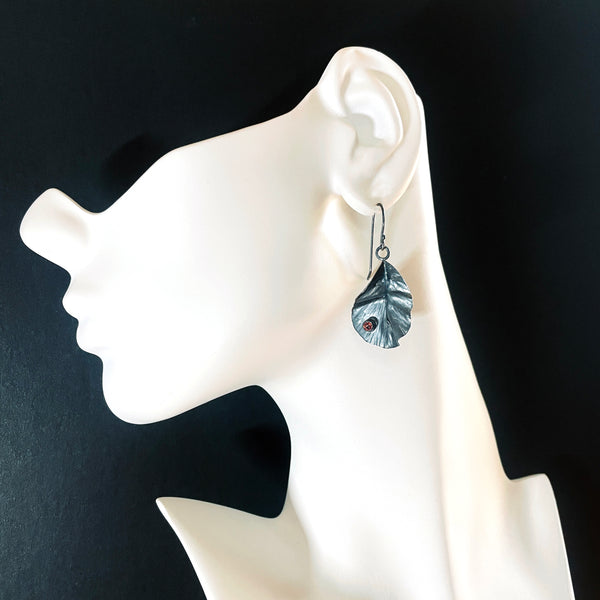 Silver leaf earrings with garnet by eko jewelry design, Chermona on model