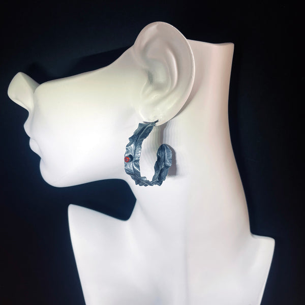 Silver leaf hoop earrings with garnet by eko jewelry design, Zinya on model.